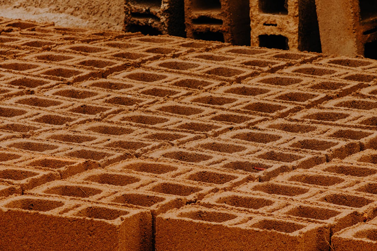 Close-up view of patterned concrete blocks in a construction site.